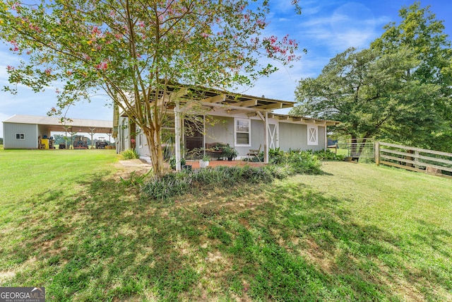 view of yard with a carport and fence