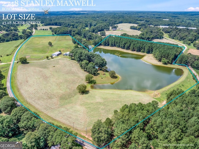 aerial view featuring a forest view and a water view