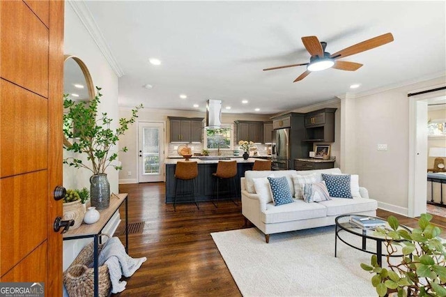 living room with crown molding, sink, ceiling fan, and dark hardwood / wood-style floors