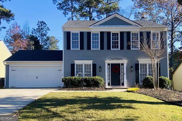 view of front of property with a front yard and a garage