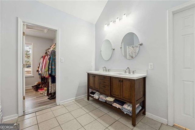 bathroom with vanity, wood-type flooring, and lofted ceiling