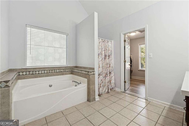 bathroom featuring a tub to relax in and tile patterned flooring