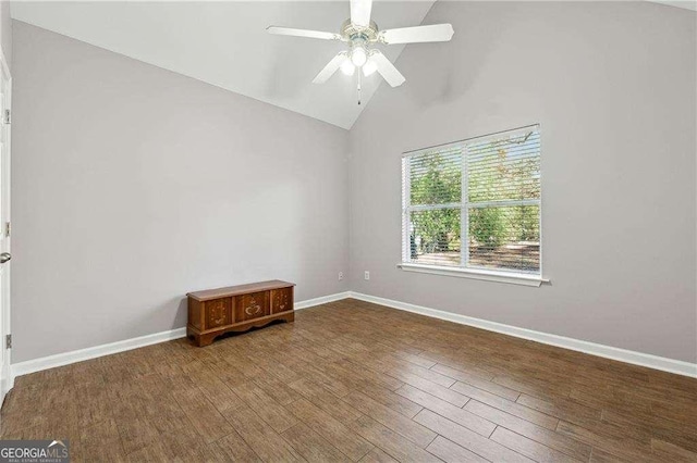 empty room with hardwood / wood-style flooring, ceiling fan, and high vaulted ceiling