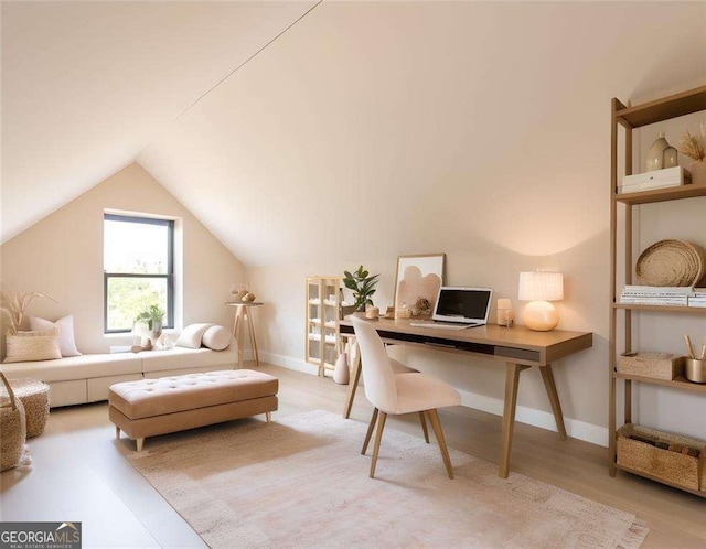 office featuring vaulted ceiling and hardwood / wood-style flooring