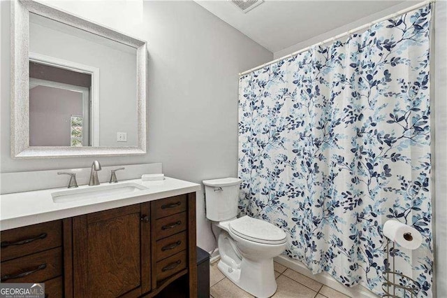 bathroom with tile patterned floors, vanity, and toilet