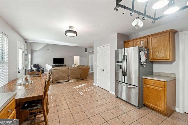 kitchen with stainless steel fridge with ice dispenser and light tile patterned flooring