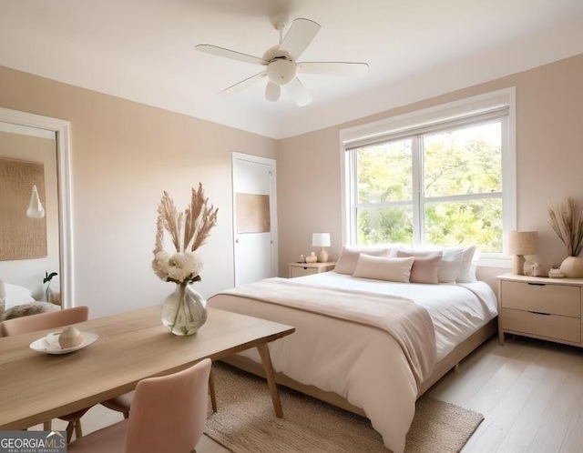 bedroom featuring light wood-type flooring and ceiling fan