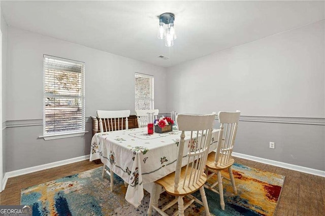 dining room with dark hardwood / wood-style floors