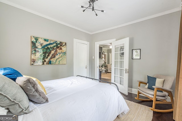 bedroom with a notable chandelier, dark hardwood / wood-style flooring, and crown molding