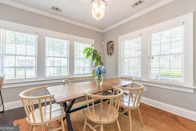 dining space with dark hardwood / wood-style floors and ornamental molding