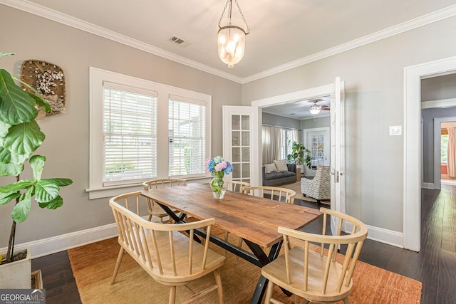 dining space with ceiling fan with notable chandelier, dark hardwood / wood-style flooring, and ornamental molding