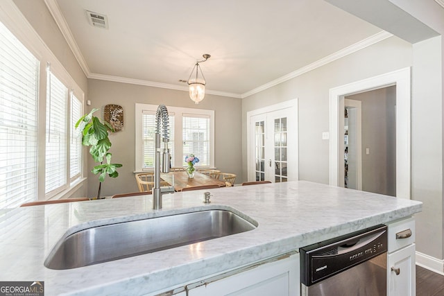 kitchen with a wealth of natural light, pendant lighting, stainless steel dishwasher, and sink