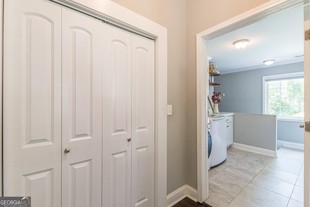 interior space with washer / dryer and light tile patterned floors