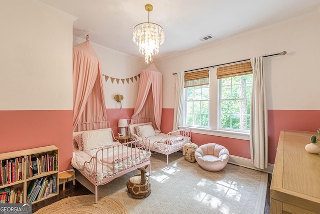 living area featuring hardwood / wood-style flooring, crown molding, and a notable chandelier