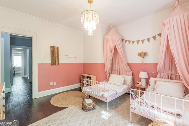 bedroom featuring hardwood / wood-style floors, a notable chandelier, and crown molding