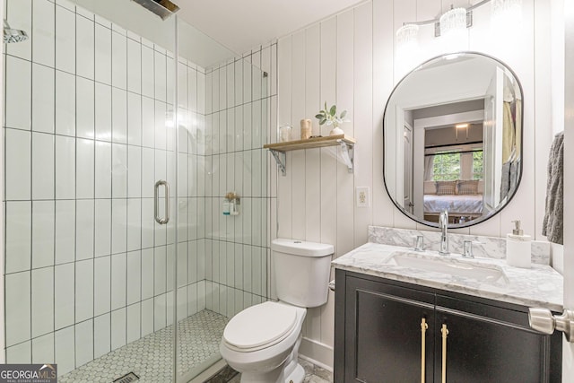 bathroom featuring vanity, wood walls, toilet, and walk in shower