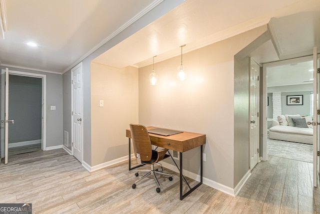 home office featuring light hardwood / wood-style flooring and crown molding