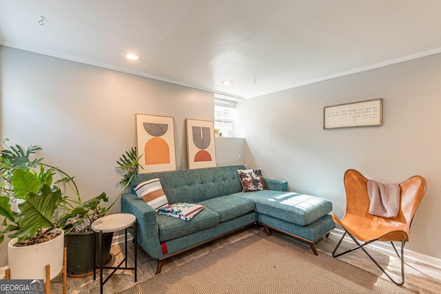 living room with hardwood / wood-style flooring and ornamental molding