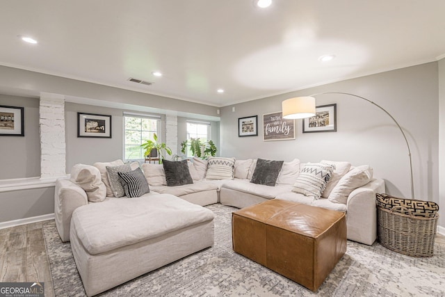 living room with hardwood / wood-style floors and ornamental molding