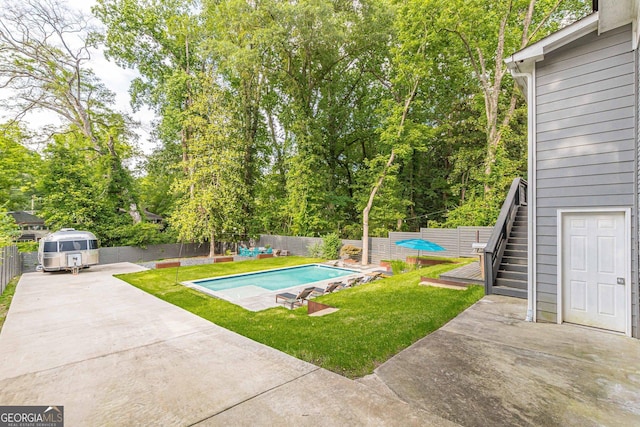 view of pool featuring a patio area, a yard, and a wooden deck