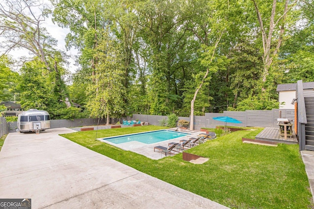 view of swimming pool with a patio area, a yard, grilling area, and a deck