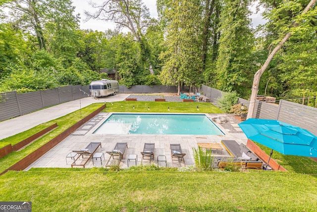 view of swimming pool with a lawn and a patio