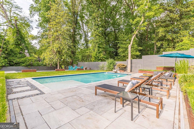 view of swimming pool featuring a patio area