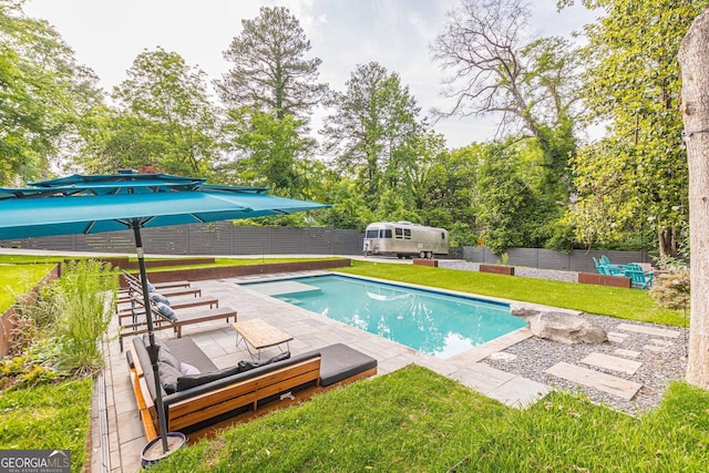 view of swimming pool with a yard and a patio