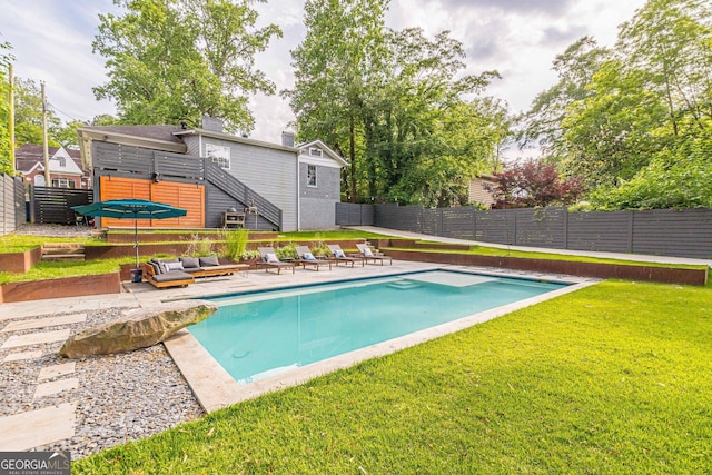 view of pool with a yard and a patio