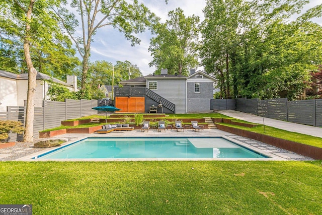 view of pool featuring a lawn