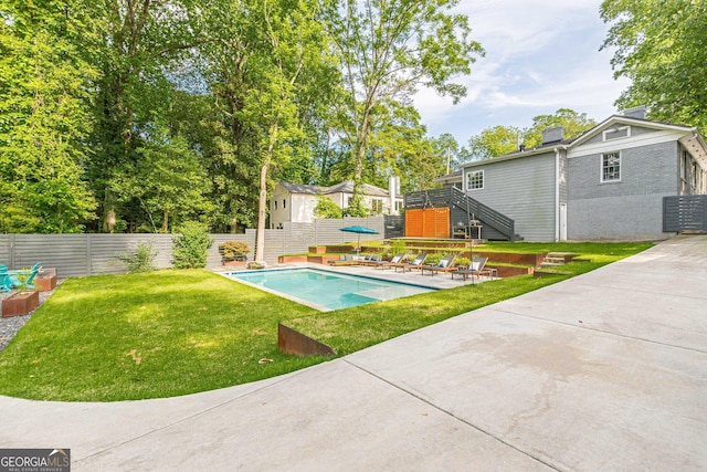 view of swimming pool featuring a yard and a patio