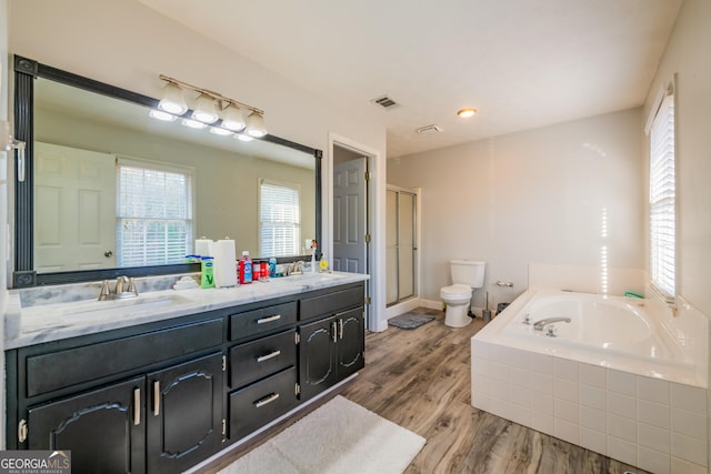 full bathroom with hardwood / wood-style floors, vanity, toilet, and shower with separate bathtub