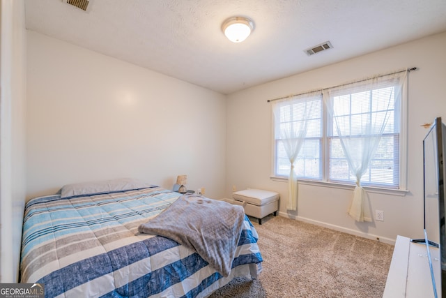 carpeted bedroom featuring a textured ceiling