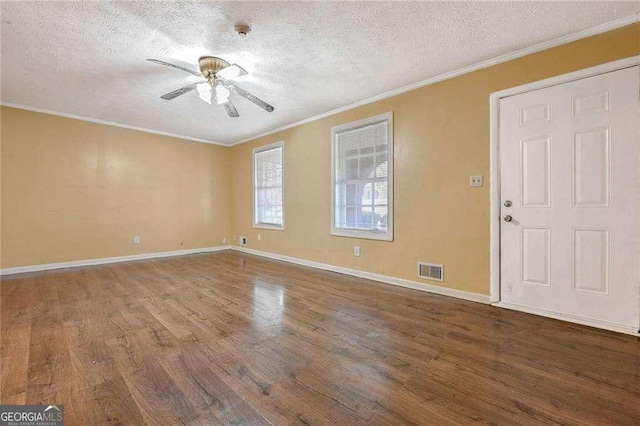 interior space featuring hardwood / wood-style flooring, ceiling fan, crown molding, and a textured ceiling