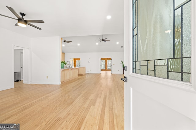 unfurnished living room with light wood-type flooring and sink