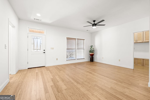 unfurnished living room with ceiling fan and light wood-type flooring