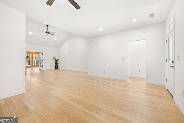 unfurnished living room with high vaulted ceiling and light wood-type flooring