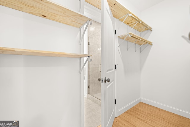 walk in closet featuring hardwood / wood-style flooring