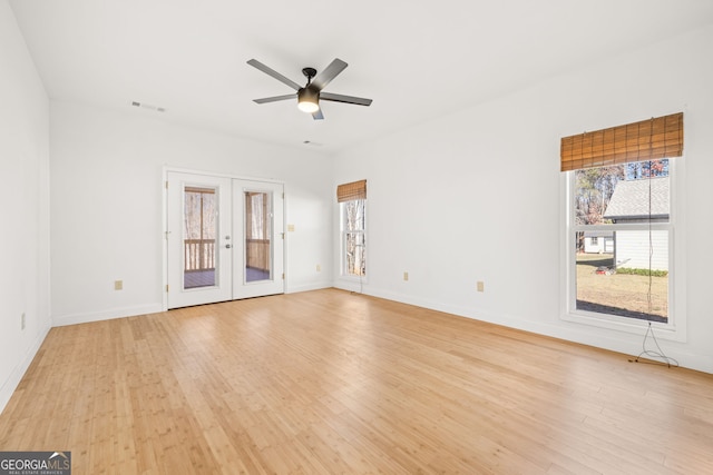 unfurnished room with ceiling fan, light hardwood / wood-style flooring, and french doors