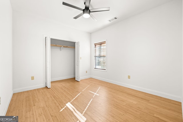 unfurnished bedroom featuring ceiling fan, wood-type flooring, and a closet