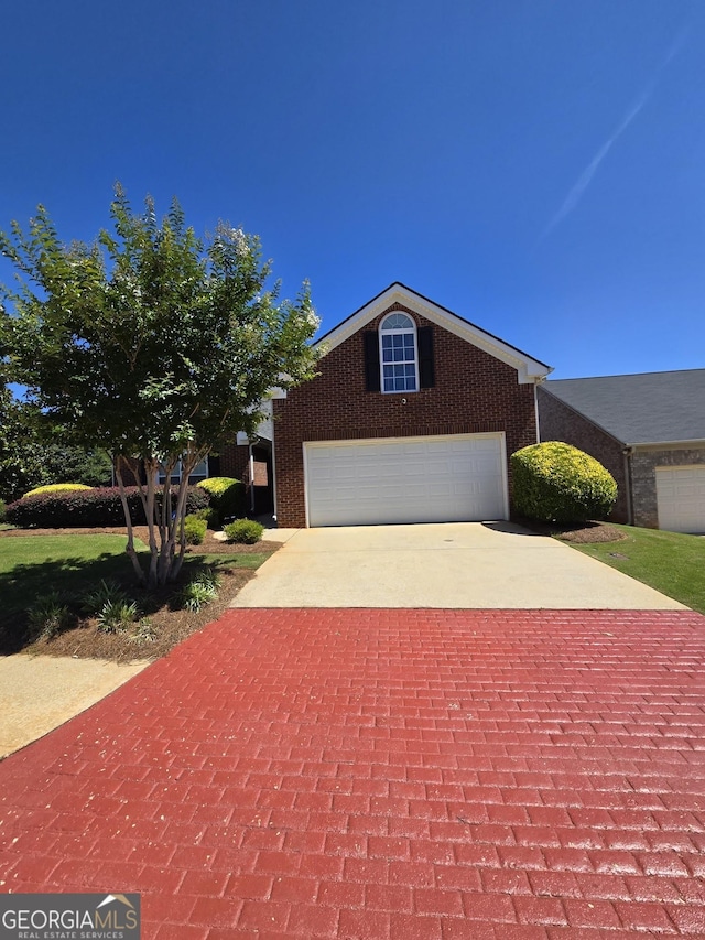 view of front of home with a garage, decorative driveway, and brick siding