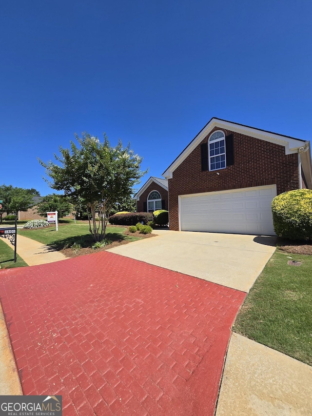 view of front facade with concrete driveway and brick siding