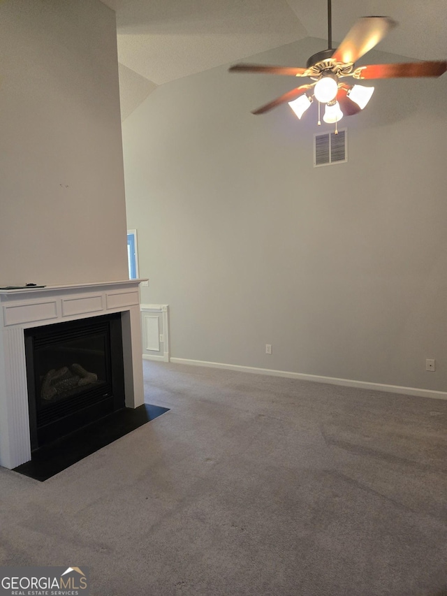 unfurnished living room with a fireplace with flush hearth, carpet flooring, visible vents, vaulted ceiling, and baseboards