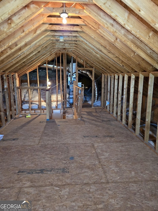 unfinished attic with an upstairs landing