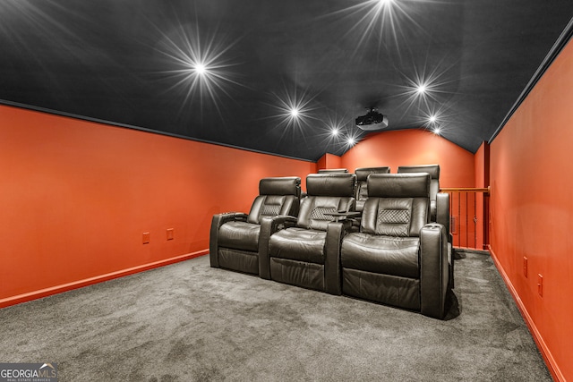 carpeted cinema room with lofted ceiling