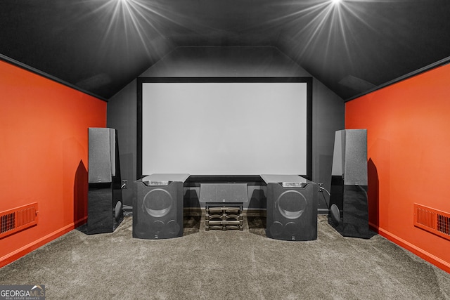 carpeted home theater room featuring vaulted ceiling