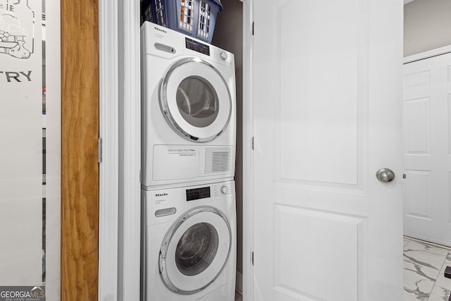 washroom featuring stacked washer and clothes dryer