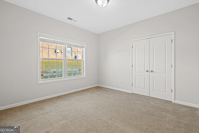 unfurnished bedroom featuring carpet and a closet