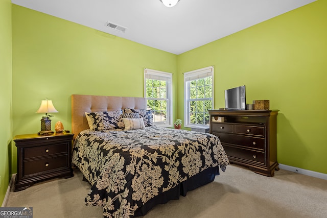 bedroom featuring light carpet