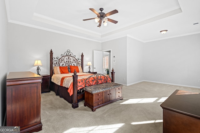 bedroom with a raised ceiling, ceiling fan, light colored carpet, and ornamental molding